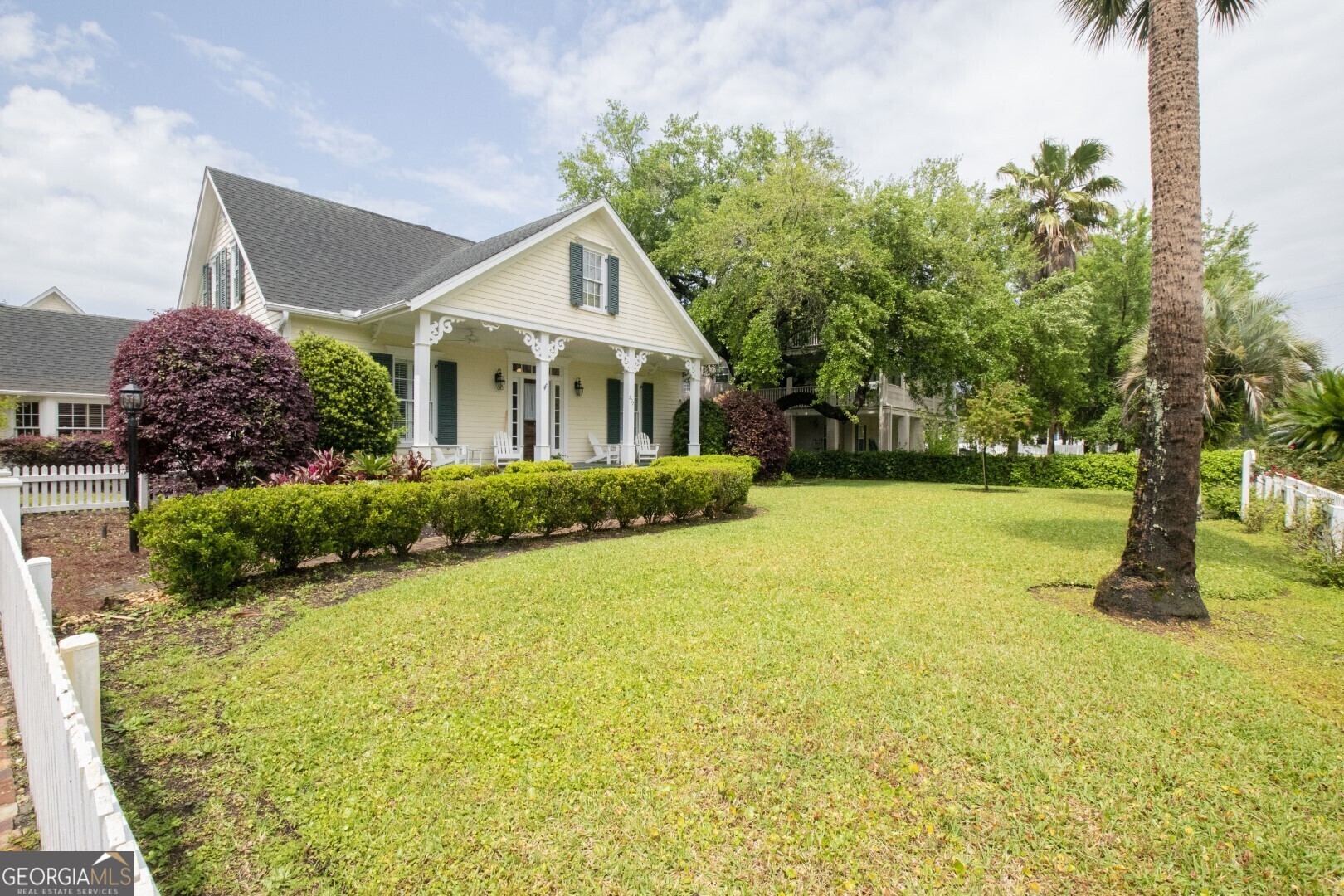 a front view of a house with garden