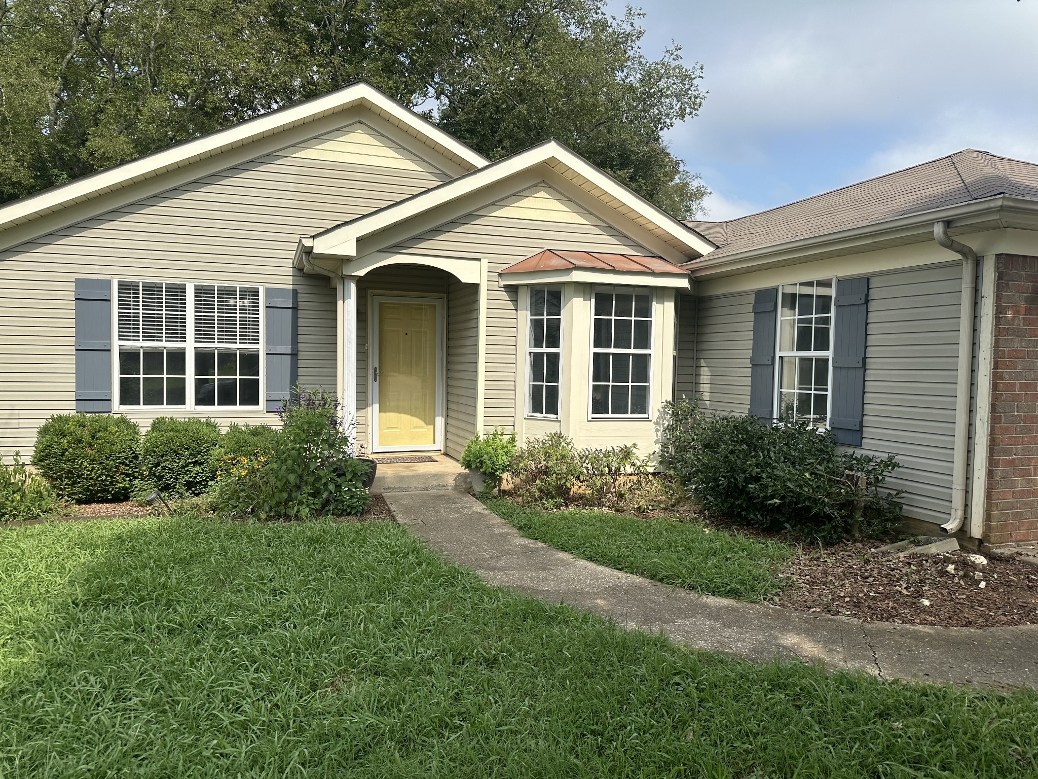 a front view of a house with garden