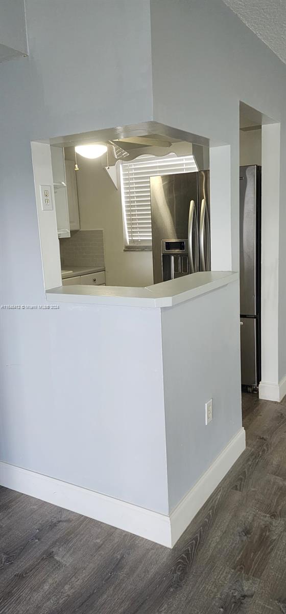 a view of a refrigerator a sink and a dishwasher