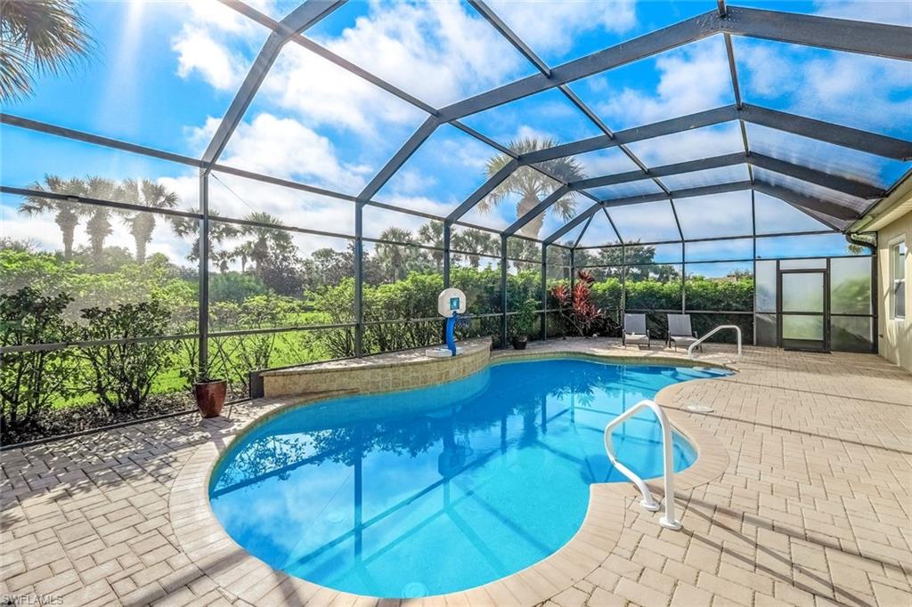 View of pool with a lanai and a patio