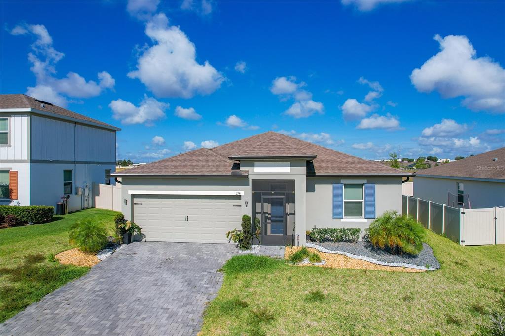 a front view of a house with a yard and garage