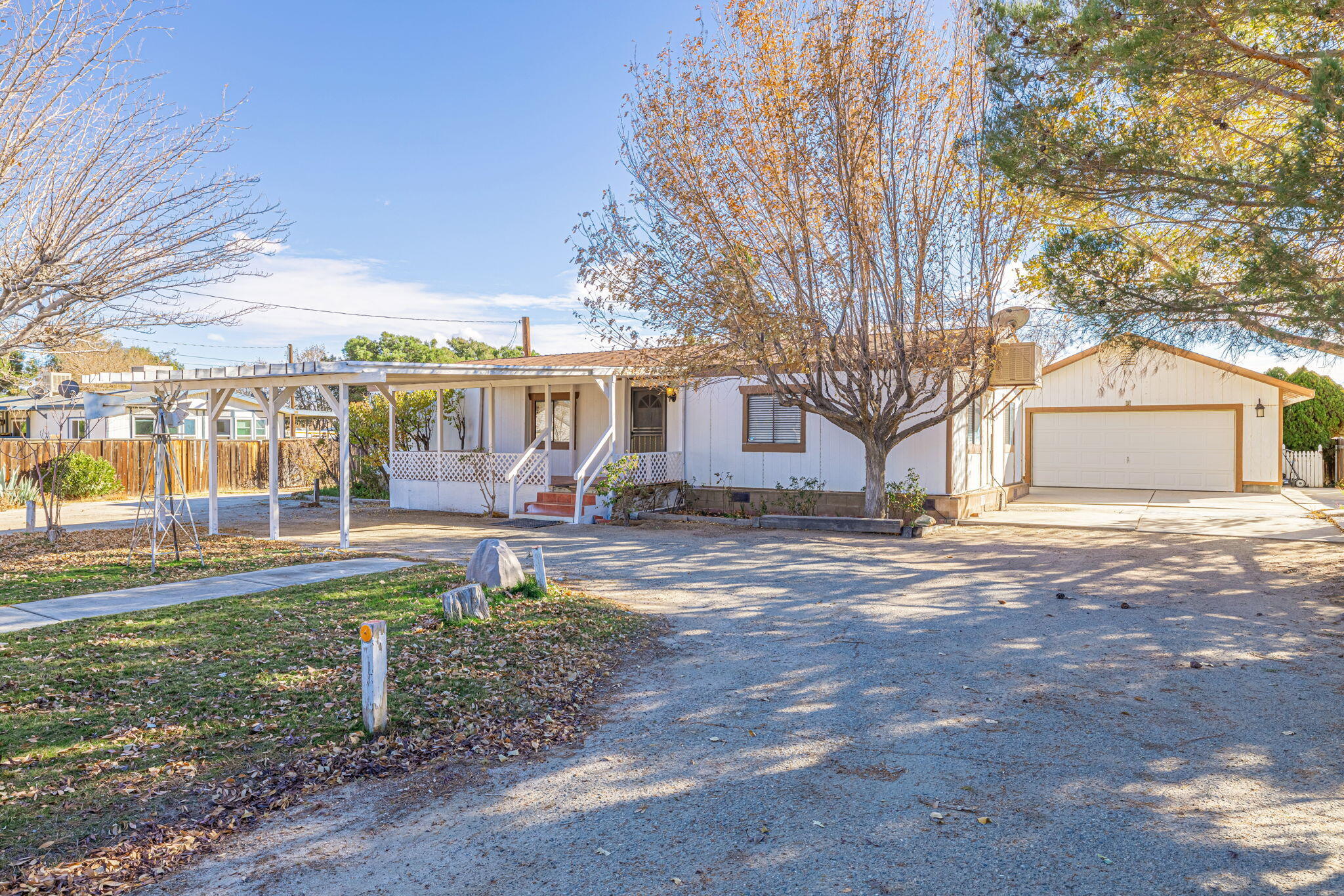 a view of a house with backyard and a tree