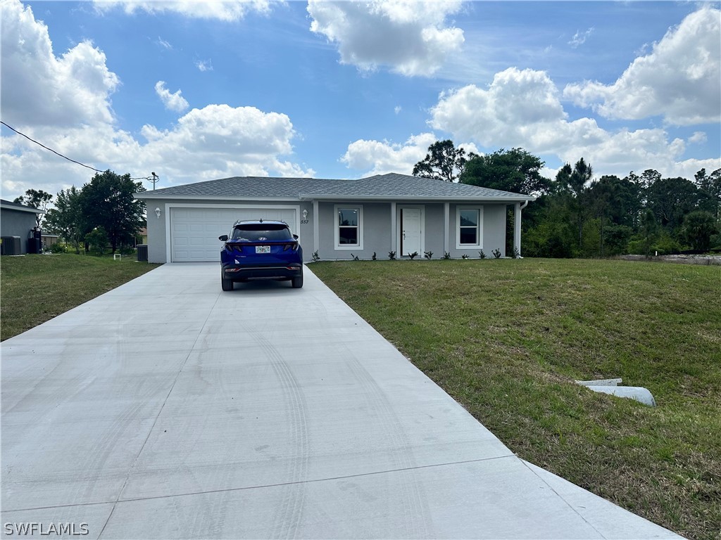 a view of a car in front of a house with a yard