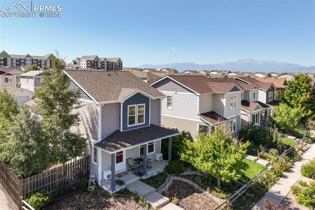 an aerial view of a house with a yard