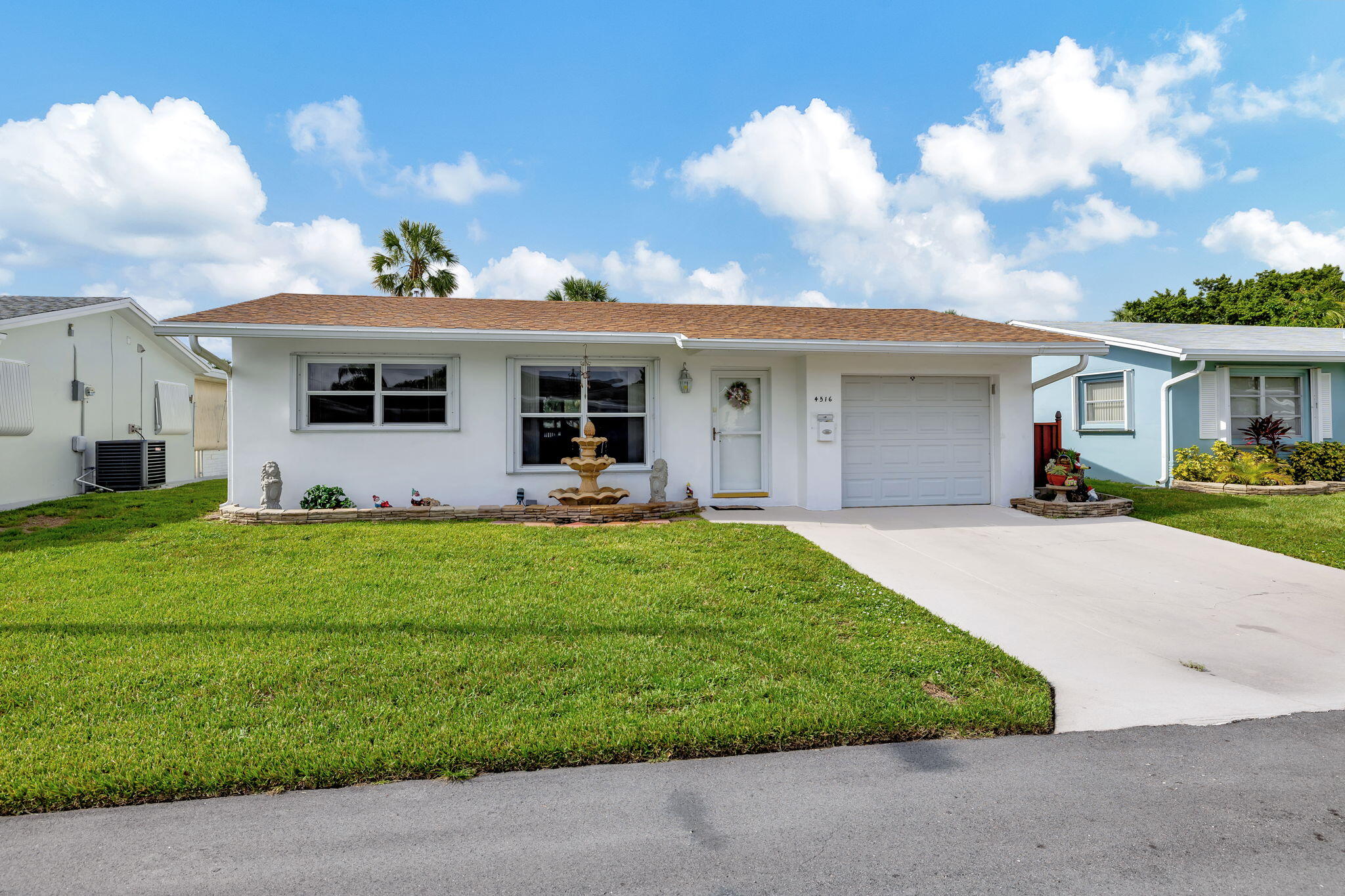 a front view of house with yard and green space