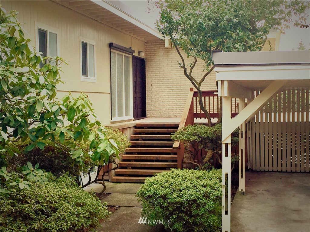 a house with potted plants in front of it