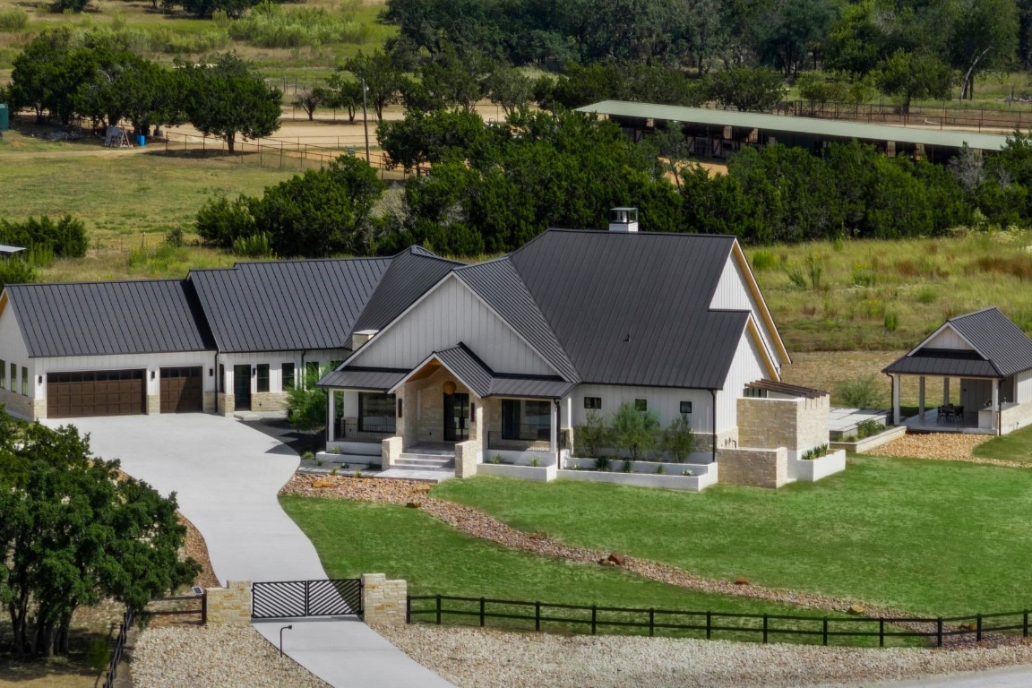 a aerial view of a house with a yard table and chairs