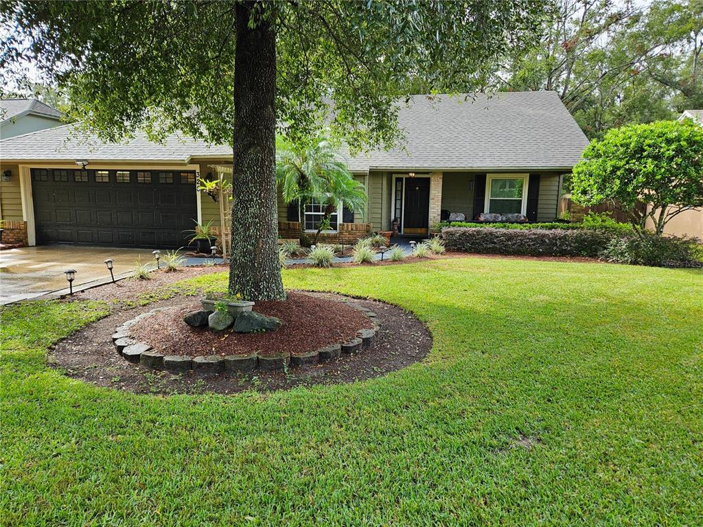 a front view of a house with garden and patio