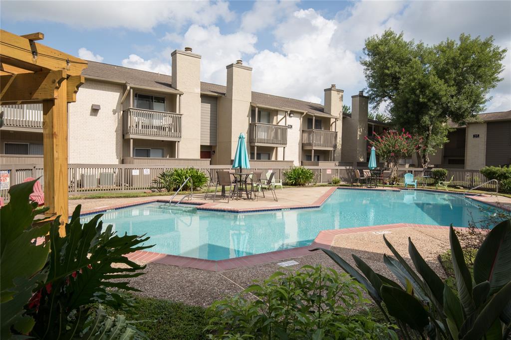 a view of a house with swimming pool and sitting area