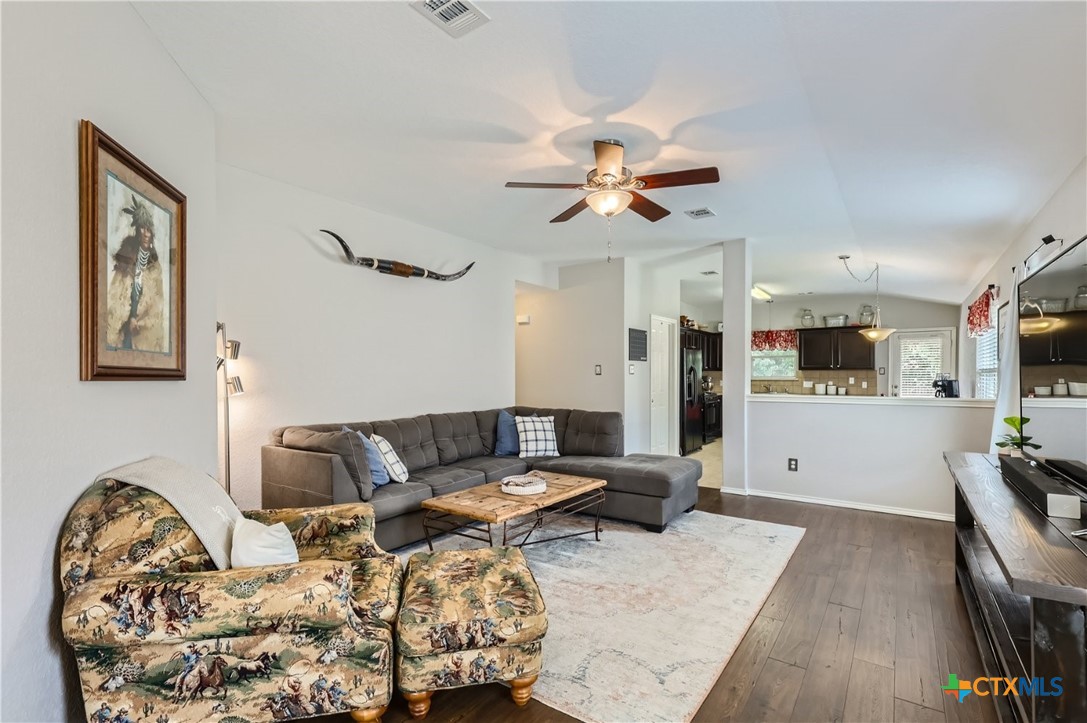 a living room with furniture and wooden floor