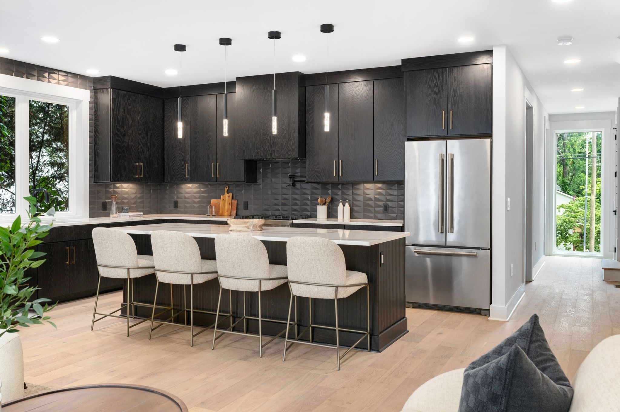 a kitchen with stainless steel appliances kitchen island granite countertop a refrigerator and a sink