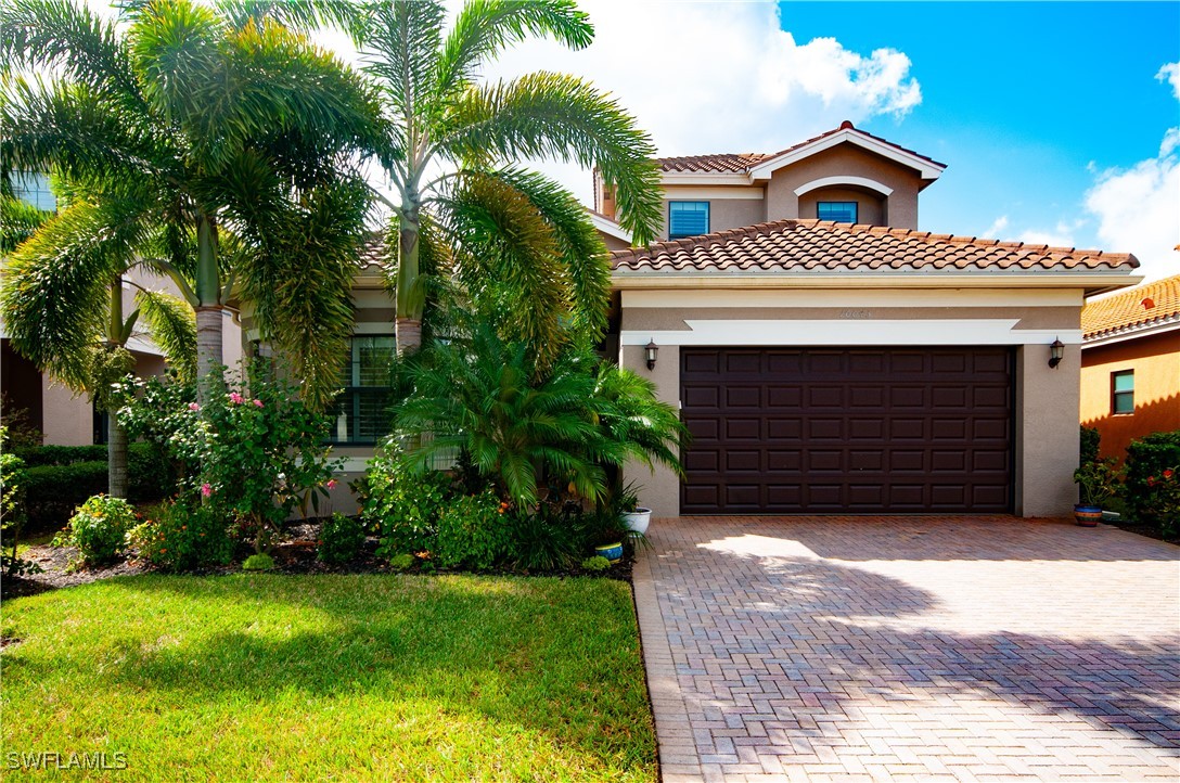 a front view of a house with a yard and garage