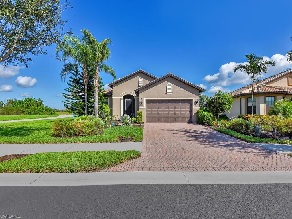 a front view of a house with a yard and garage