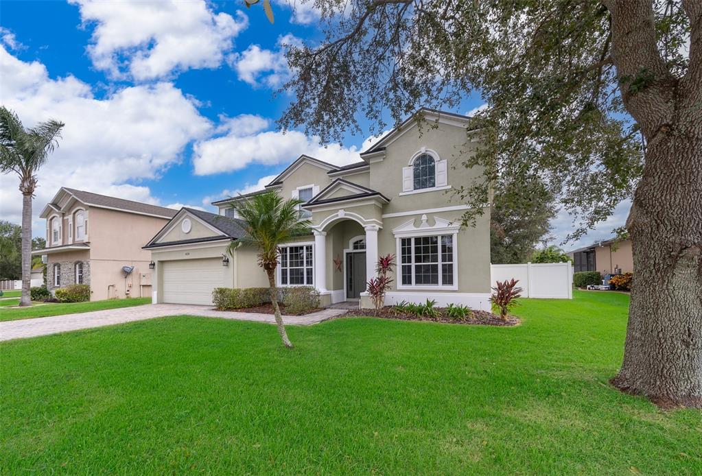 a front view of house with yard and green space