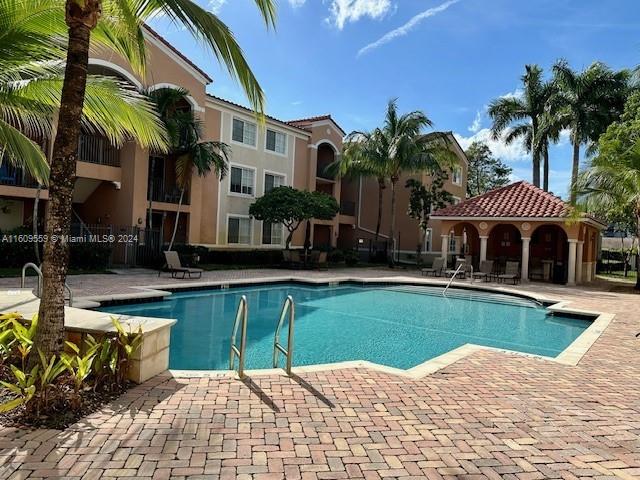 a view of a house with swimming pool and sitting area