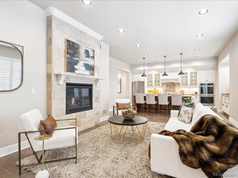 a living room with furniture kitchen view and a fireplace