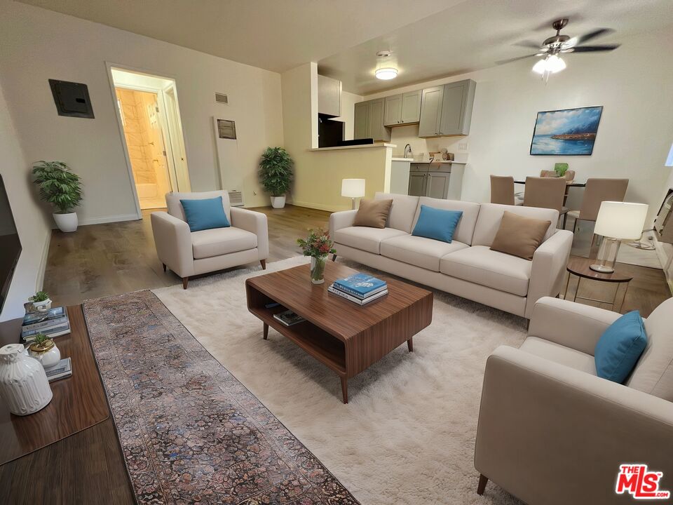 a living room with furniture and a wooden floor