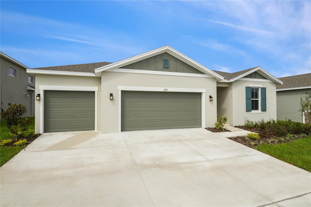 a front view of a house with yard and garage