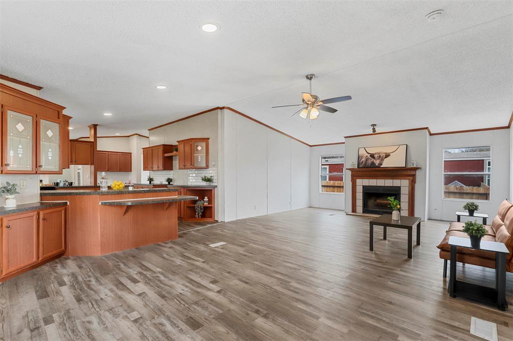 a open kitchen with cabinets countertop stainless steel appliances dining table and chairs