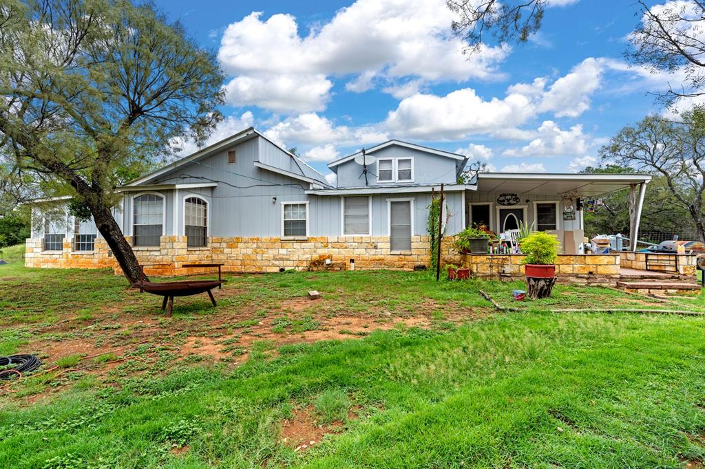 a view of a house with backyard porch and sitting area