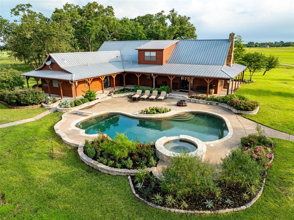 a front view of a house with swimming pool having outdoor seating