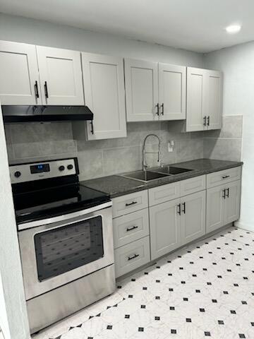 a kitchen with white cabinets and appliances