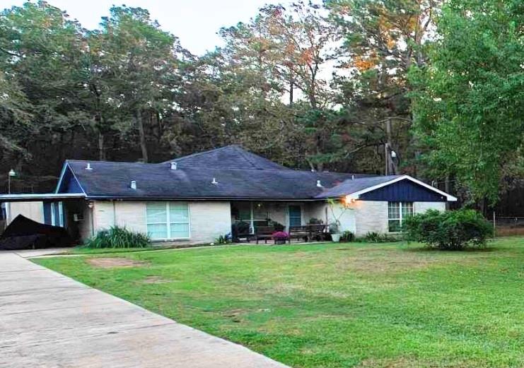 a front view of house with yard and green space