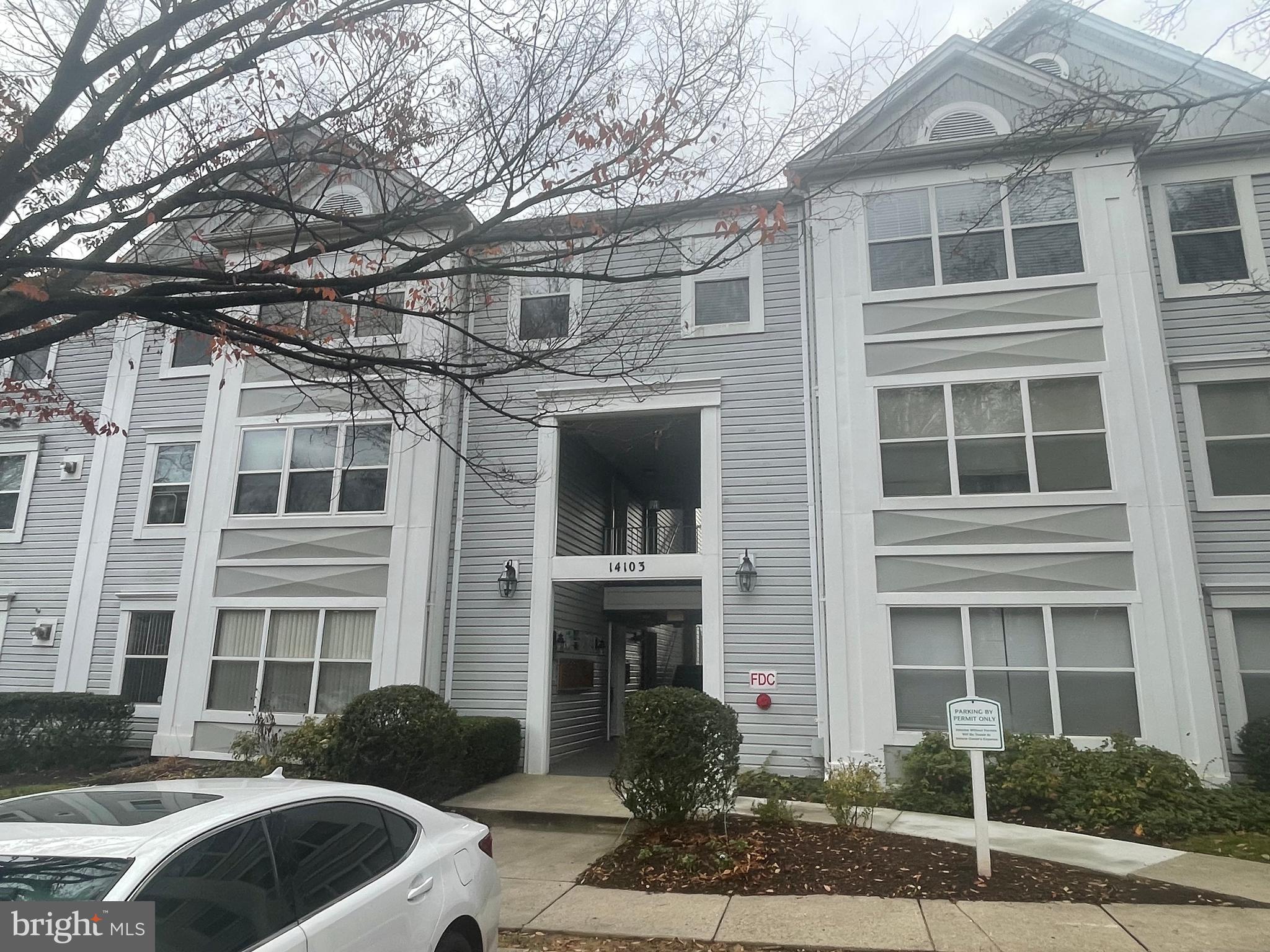 a front view of a house with outdoor space and parking