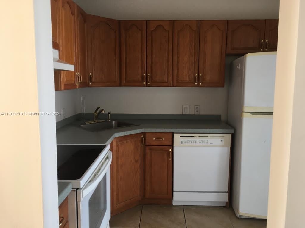 a kitchen with a refrigerator and a stove