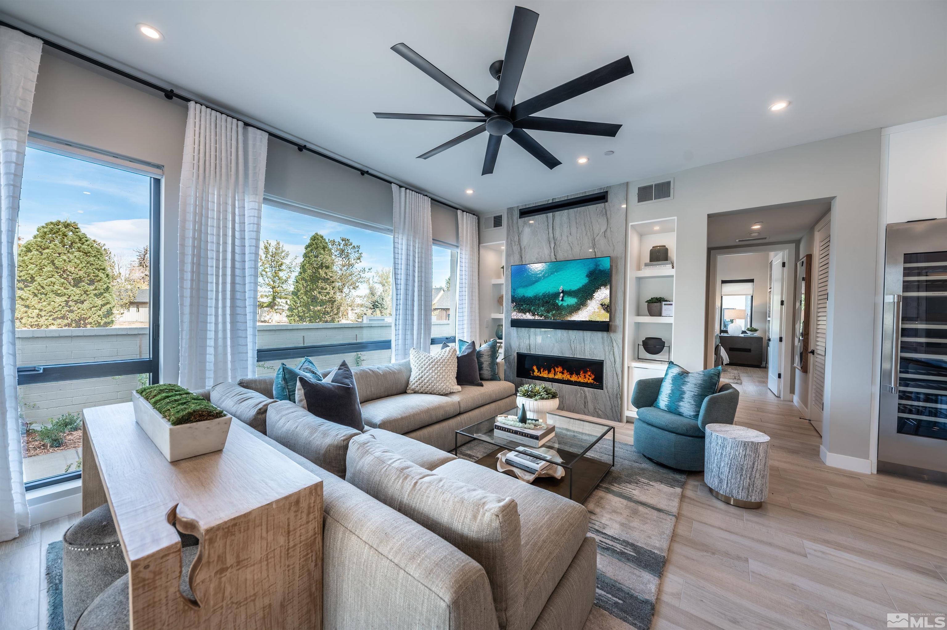 a living room with furniture a window and a ceiling fan