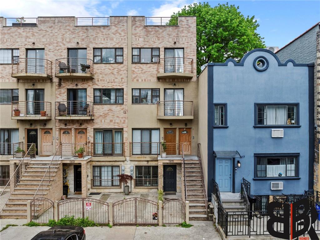 a front view of a residential apartment building with a yard