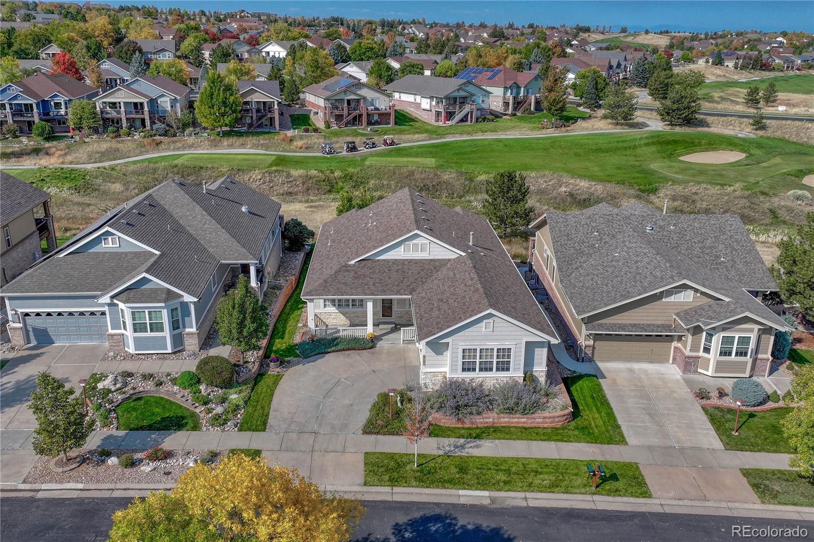 an aerial view of a house with a yard and outdoor seating