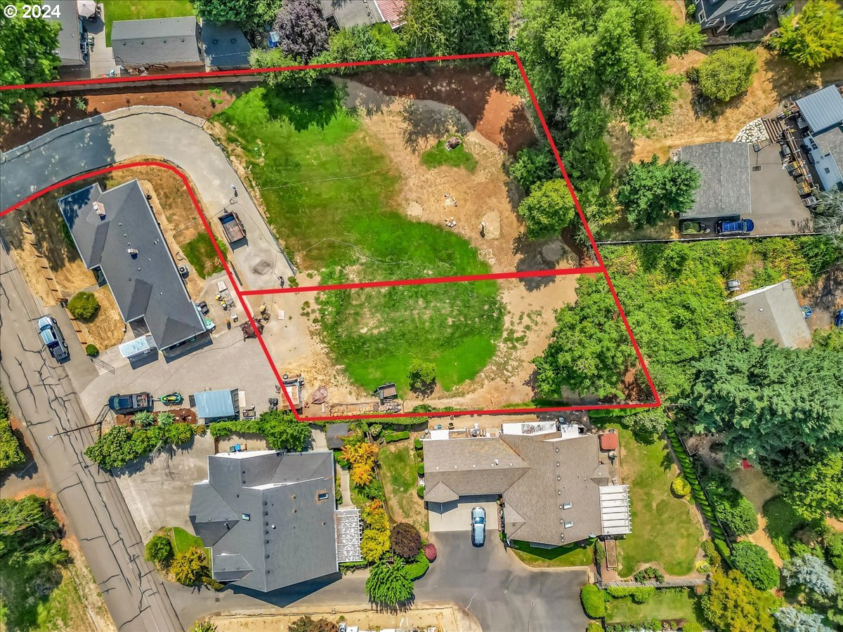 an aerial view of a house with a garden and swimming pool