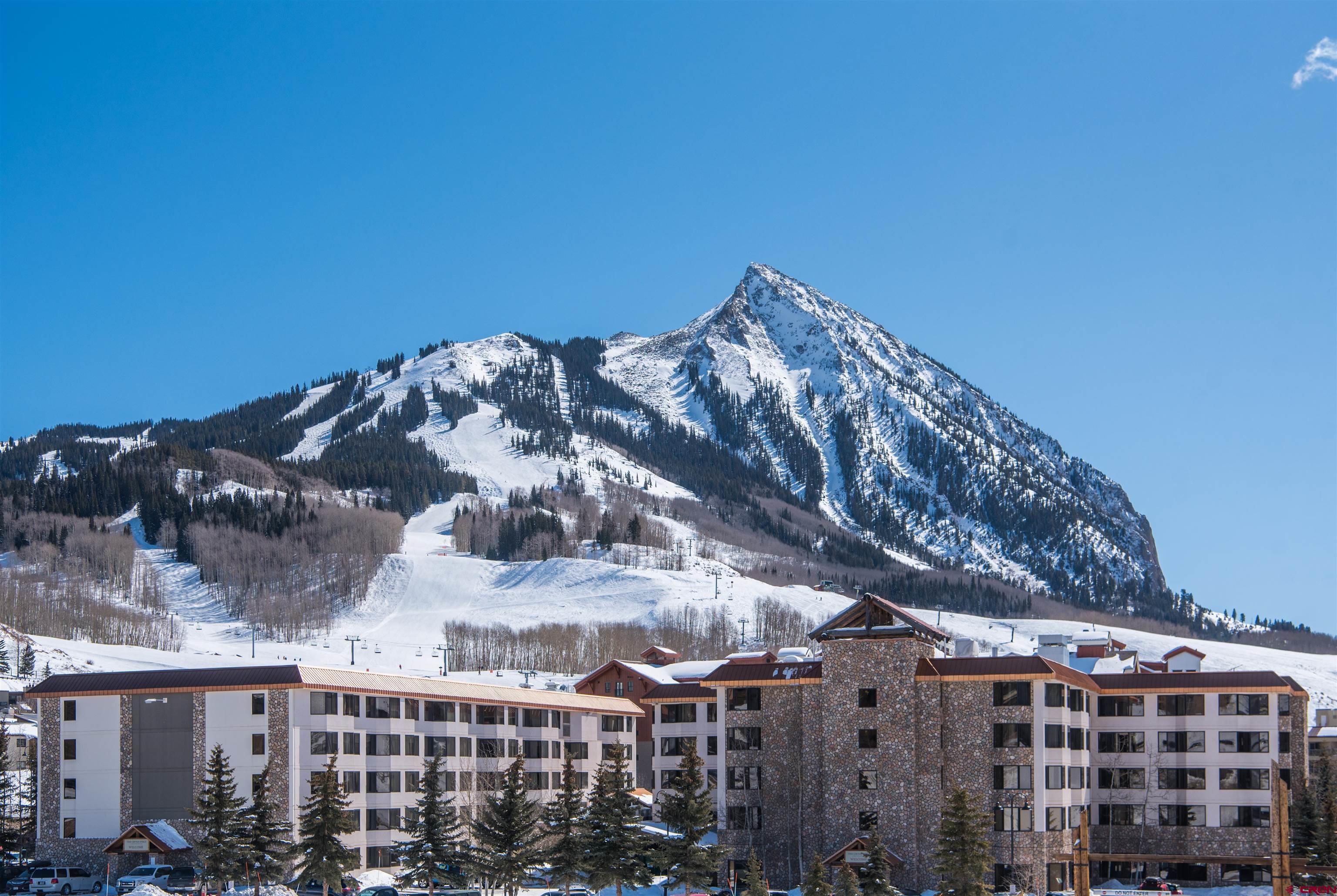 a view of building with a mountain in the background