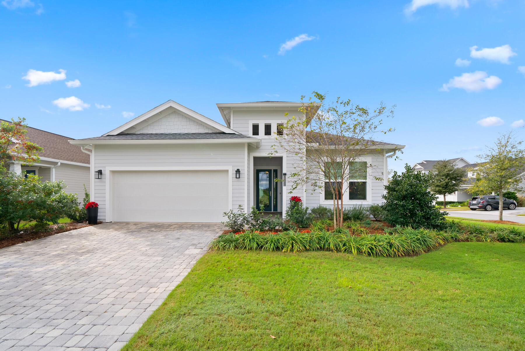 a front view of a house with a garden and yard