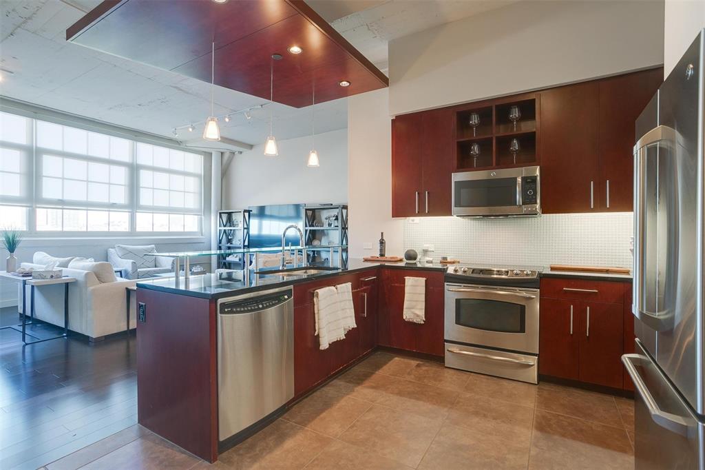 a kitchen with stainless steel appliances granite countertop a stove and a sink