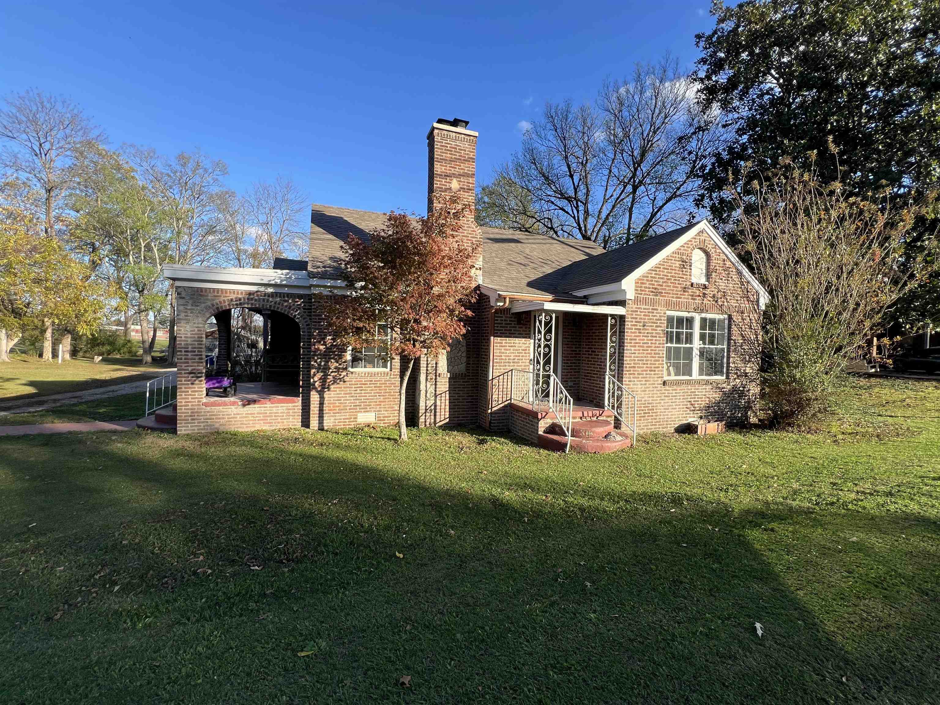 Rear view of property with a yard