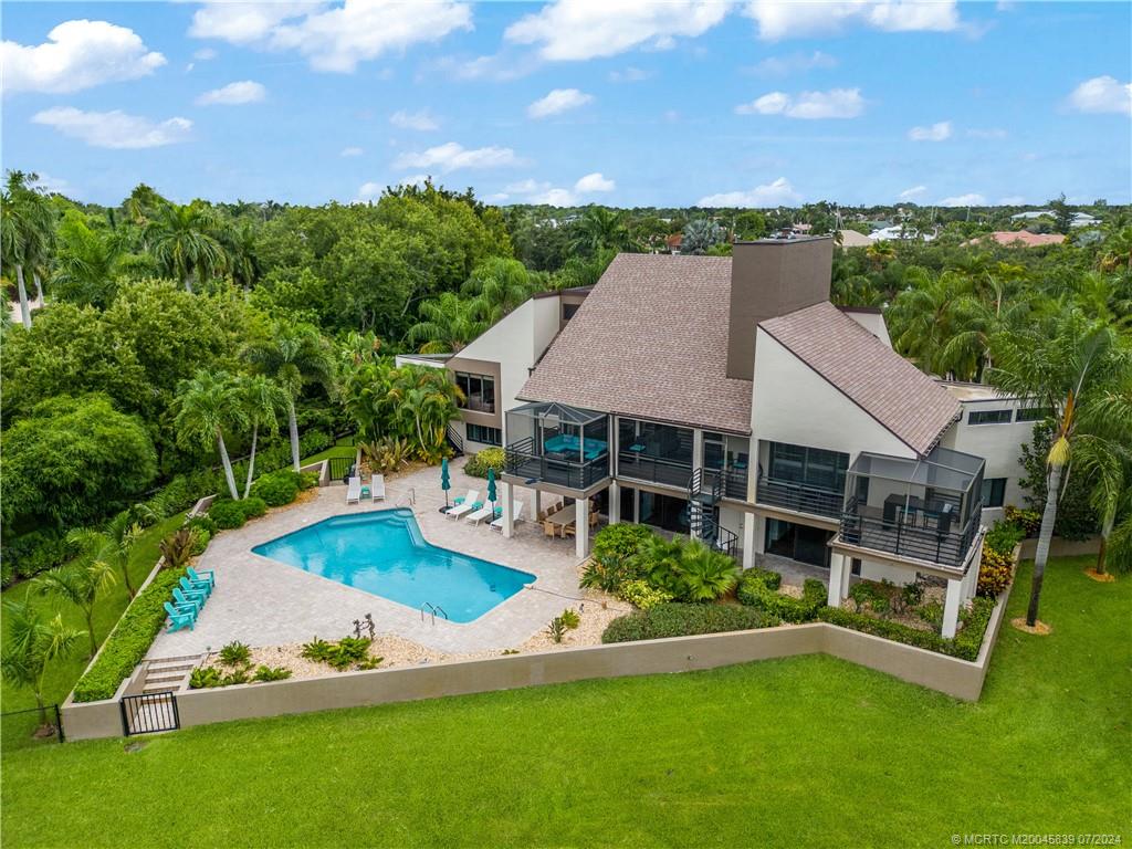 an aerial view of a house having swimming pool garden and patio