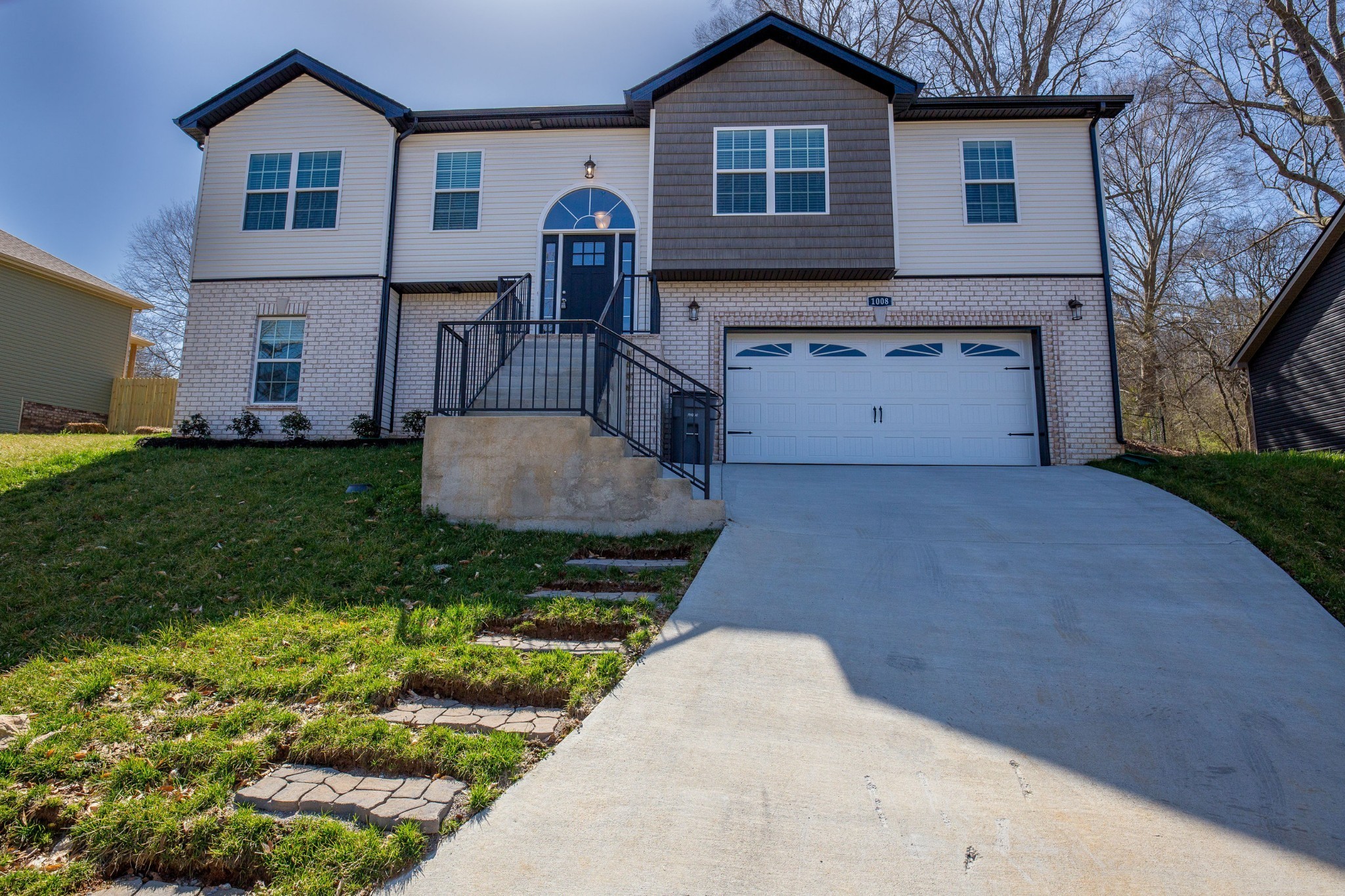 a front view of a house with a garden and yard