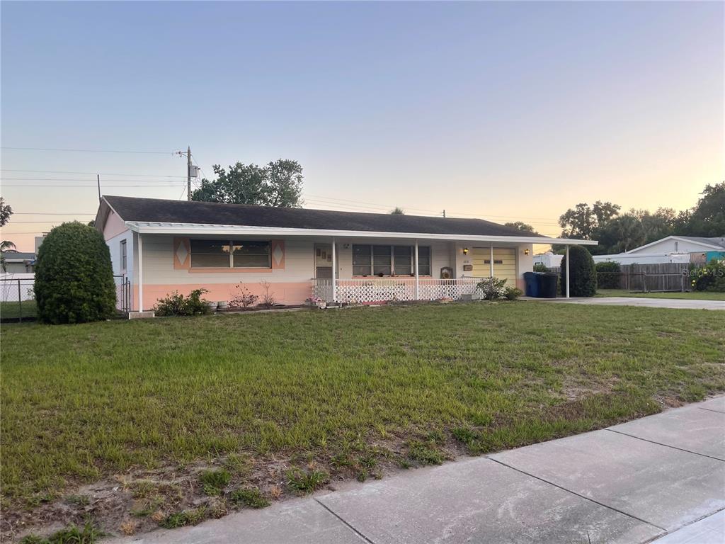 a view of a house with a backyard