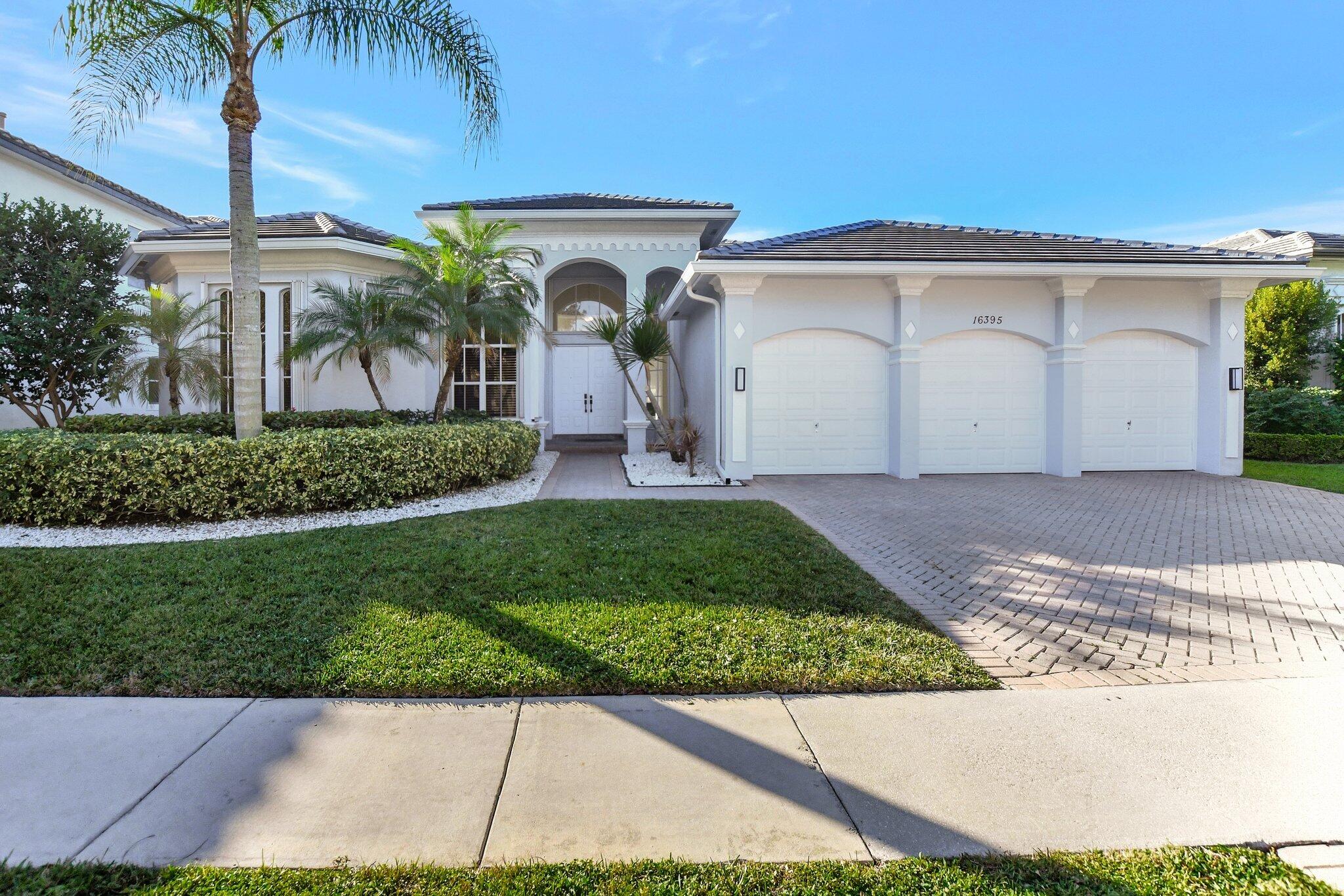 a front view of a house with a yard and a garage