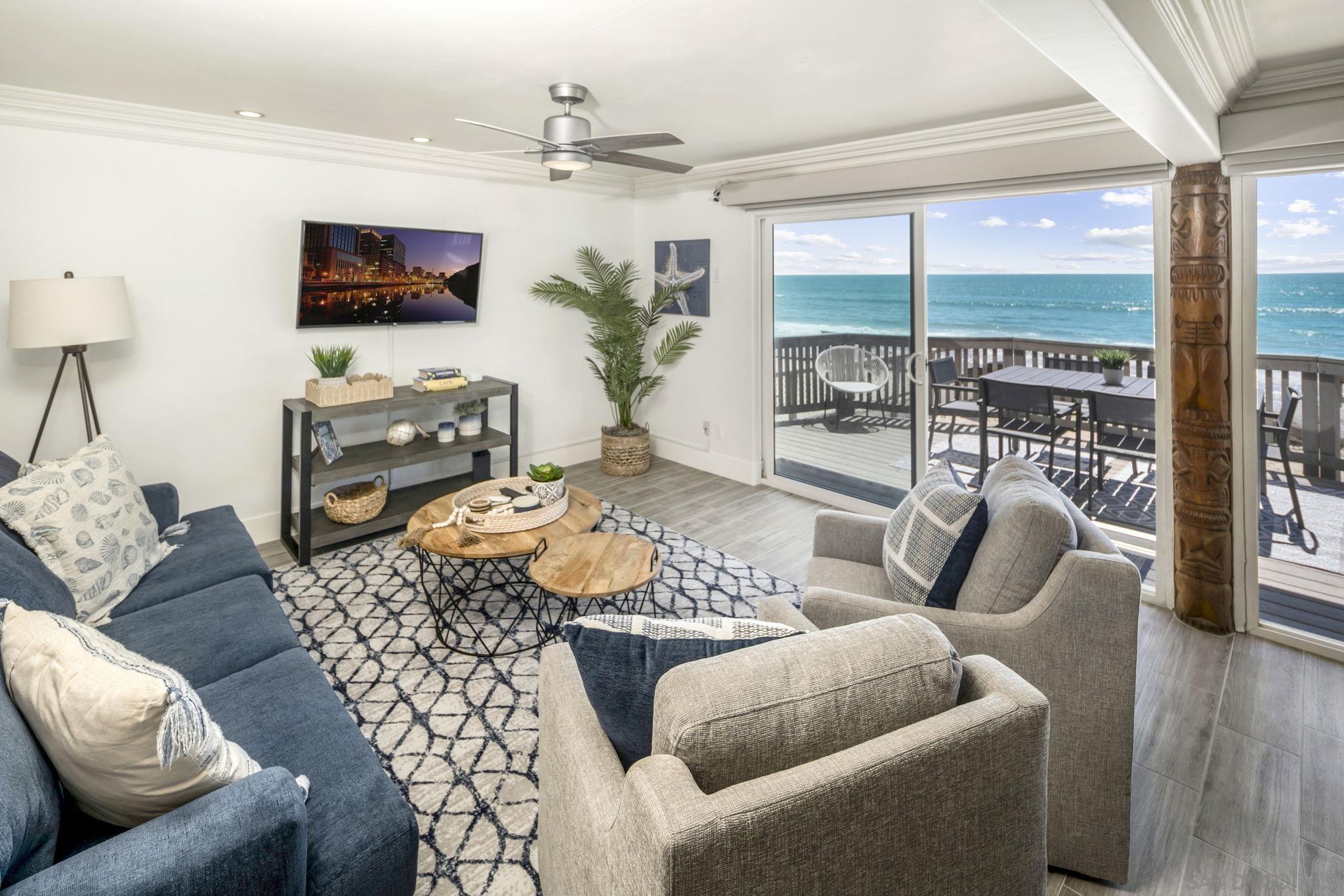 a living room with furniture a flat screen tv and a large window