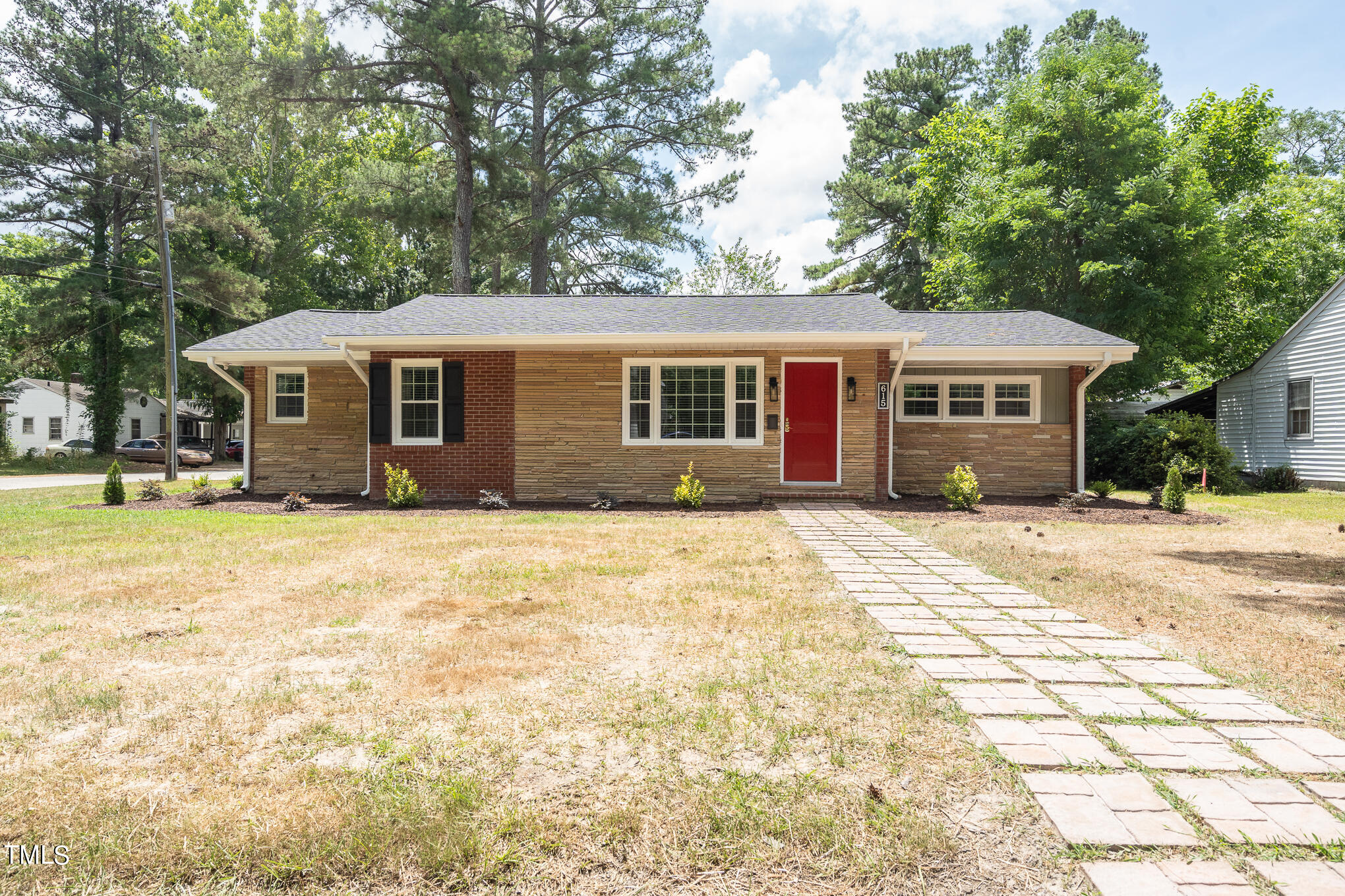 a front view of a house with a garden