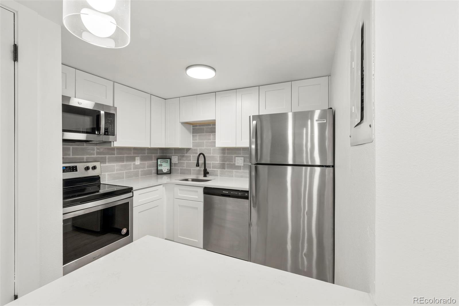 a kitchen with stainless steel appliances a refrigerator sink and cabinets