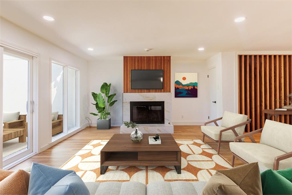 a living room with furniture a flat screen tv and a fireplace