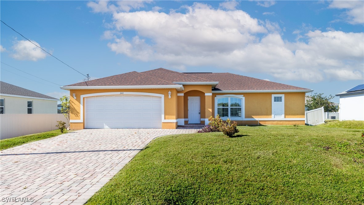 a front view of a house with yard and green space