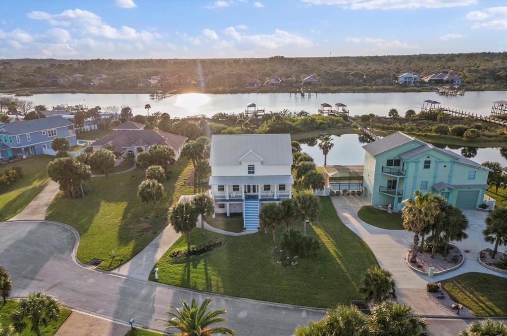 an aerial view of residential building with outdoor space and ocean view