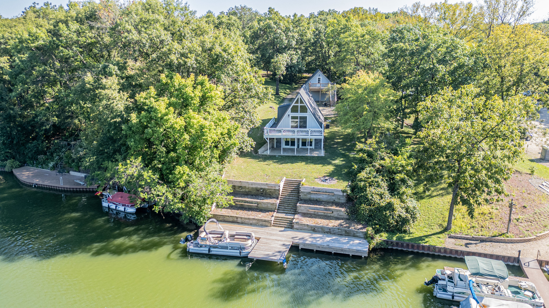 a view of a house with a yard from a lake view