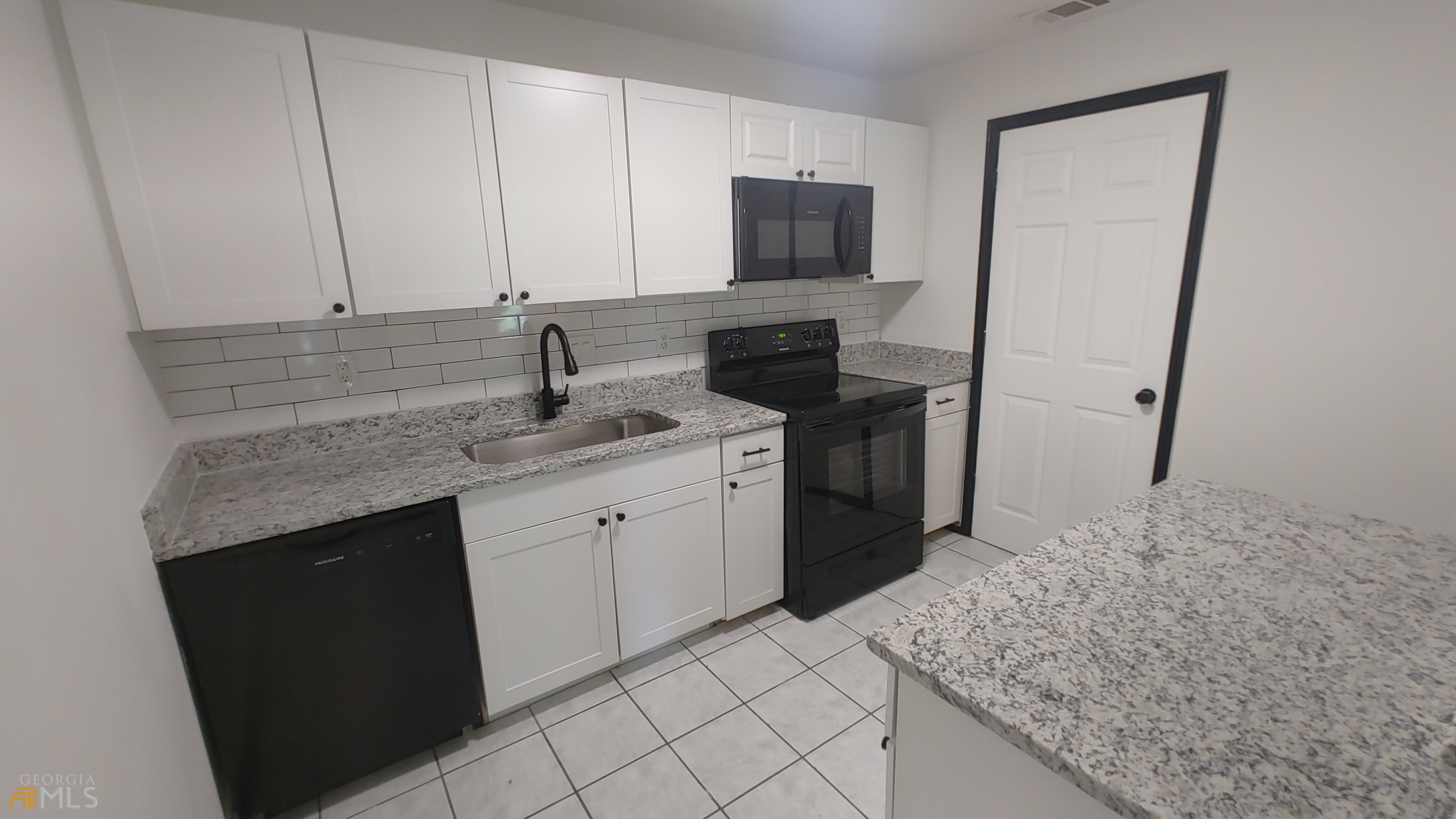 a kitchen with a sink stove and cabinets