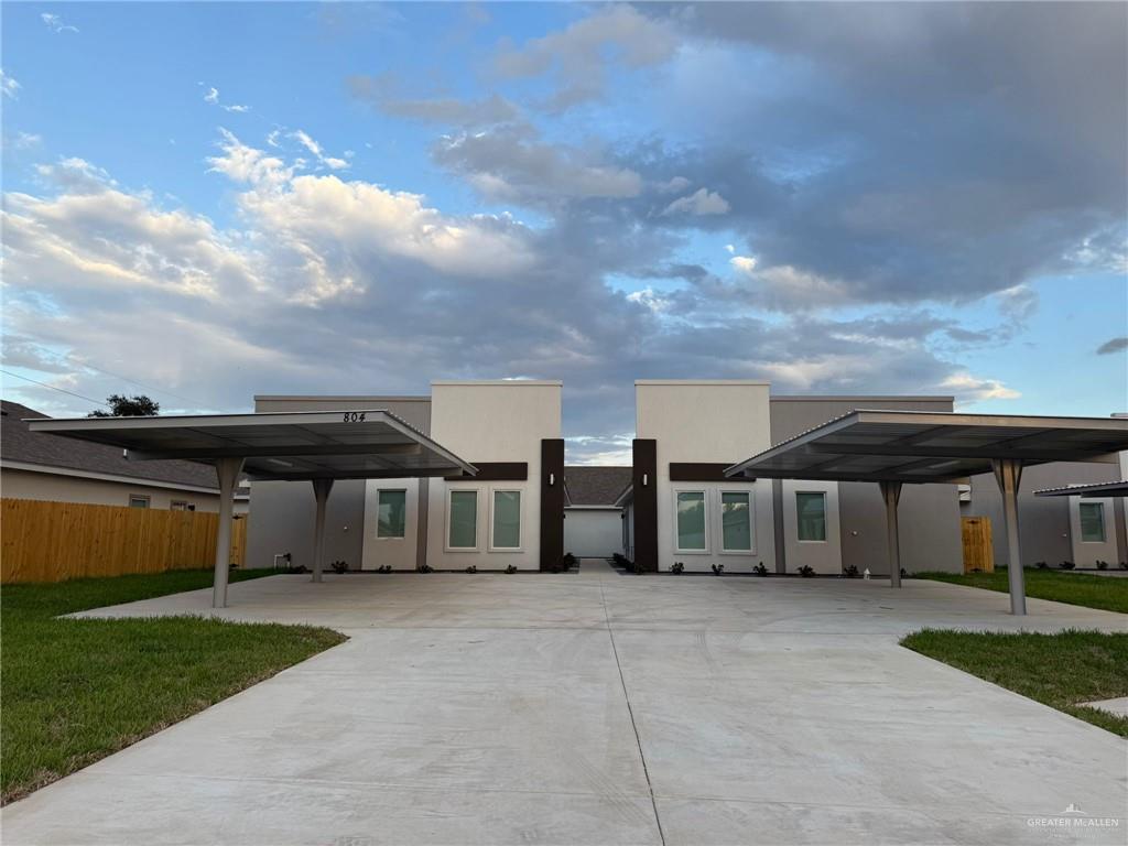 View of front of house featuring a front lawn and a carport